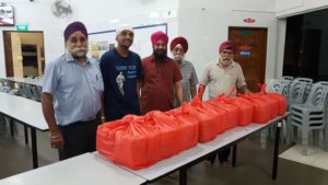 LOP volunteers at Khalsa Dharmak Sabha cook pack meals for the needy