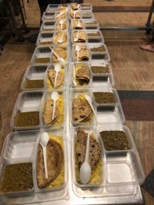 LOP volunteers cook and pack meals for the needy